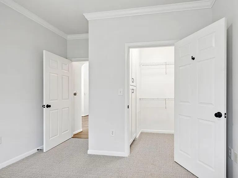 Guest bedroom entrance and walk-in closet access.