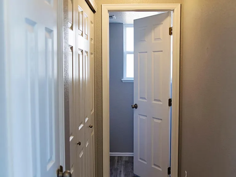 Main floor hallway with laundry hook ups, half bath and coat closet.