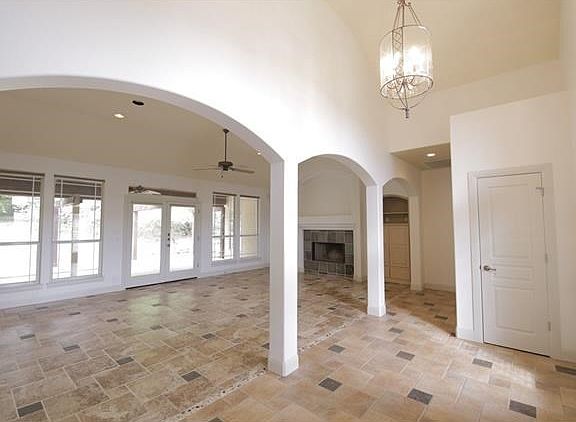 The entryway is framed high a high ceiling and beautiful arch ways.