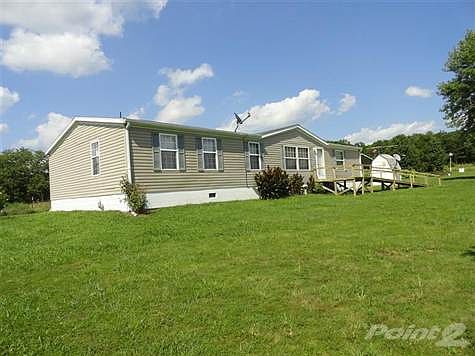 Beautiful manufactured home on concrete slab and block with 11 acres. Two large storage building/garage and extra carport.
