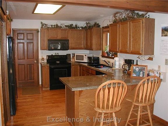 Modern kitchen with granite tile counters and hardwood floors