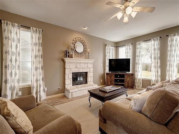 Living room with stone fireplace.
