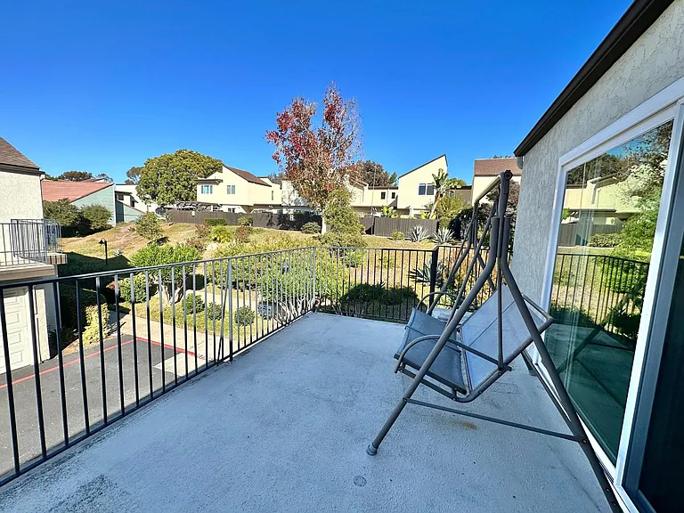 The sliding door leads to a balcony that can fit a 2-3 person swing and a 4-person patio set.