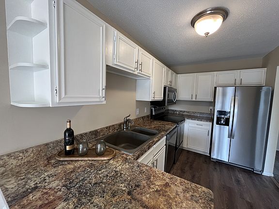 Kitchen with new LVP flooring and stainless steel appliances