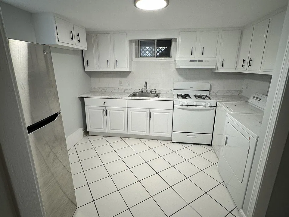 Kitchen with range and oven. Full size refrigerator and washer/dryer