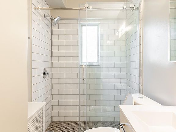 Luxurious new bath with frameless glass enclosed shower