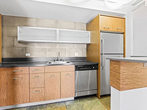 Compact kitchen with wood-tone cabinets