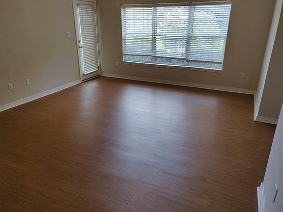 Living area from entry showing back door to porch