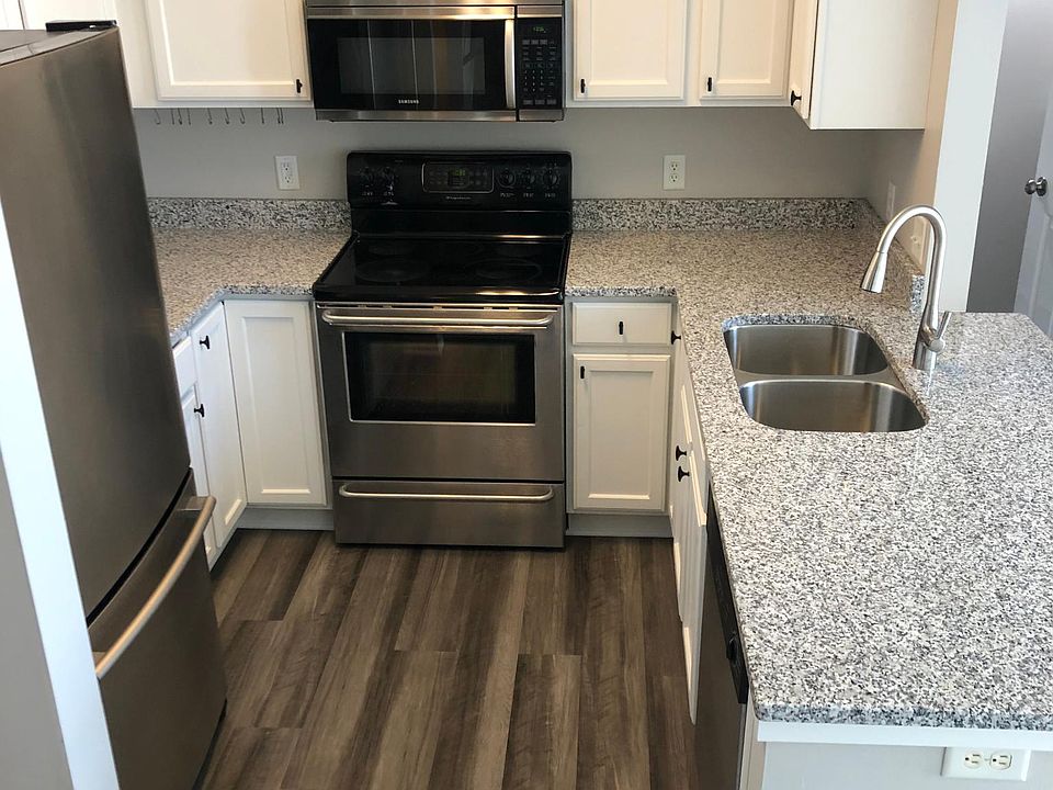Kitchen with stainless appliances and granite countertops.