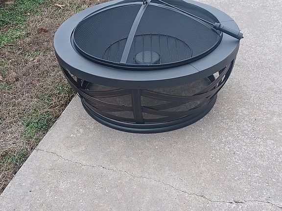 Fire pit and firewood stack provided