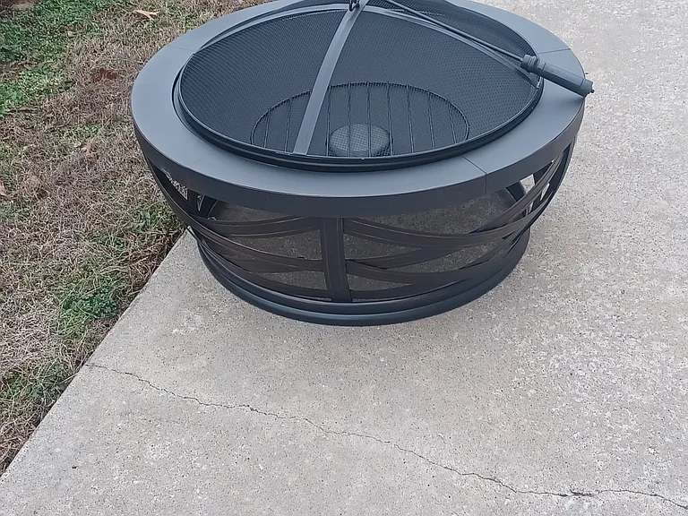 Fire pit and firewood stack provided