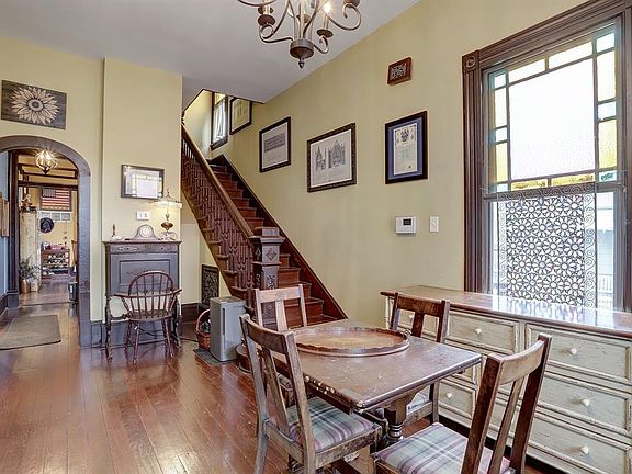 Front foyer with stained glass window on the right with staircase going to the second floor. Hallway to the left goes to the kitchen, full downstairs bath and large breakfast room in the back.