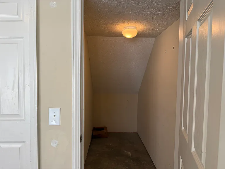The garage has a storage closet under the staircase.