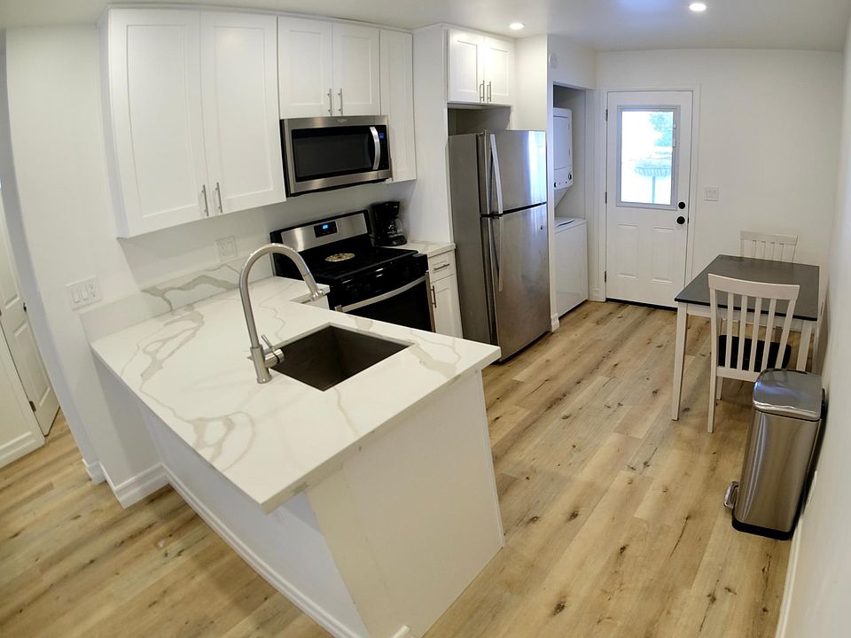 Kitchen - All stainless steel appliances, washer/dryer combo - looking towards back door