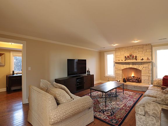 Family room addition with custom Lannon stone fireplace with limestone raised hearth.