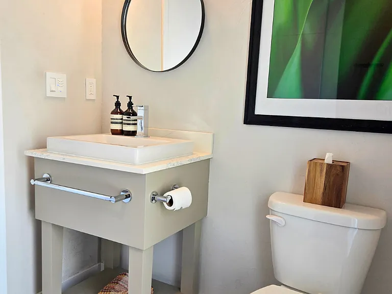 The powder room connects to a full laundry space for convenient access