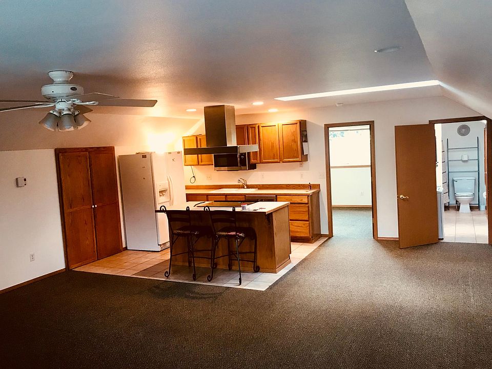Open floor plan with stacked washer/dryer in the bathroom