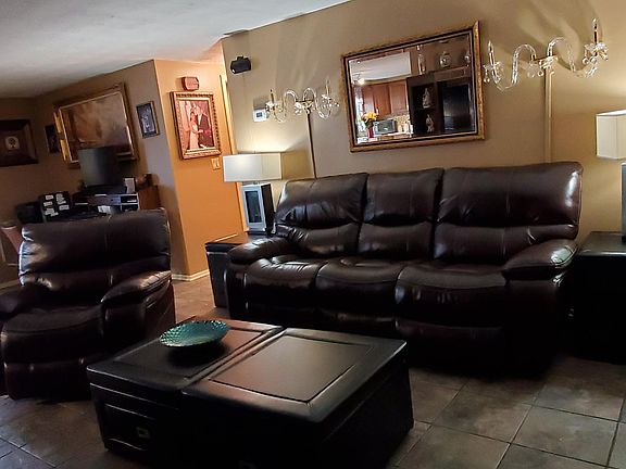 Living room is large enough for couch and recliner and tables.