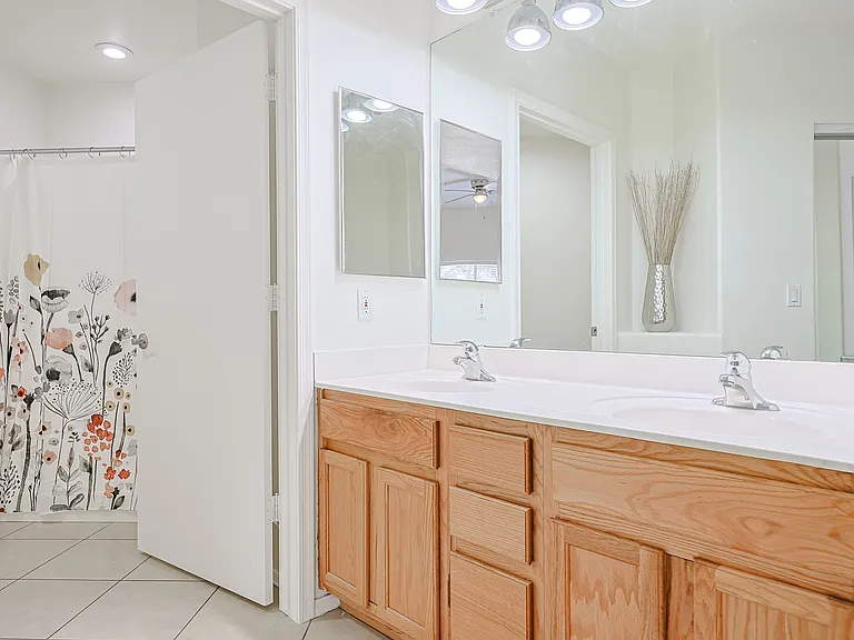 primary walk in shower and double vanities