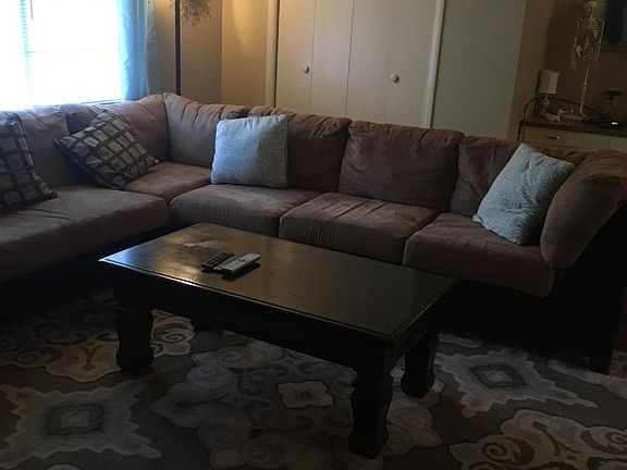 Closet in living area. Large built in desk with 5 drawers to right of closet.