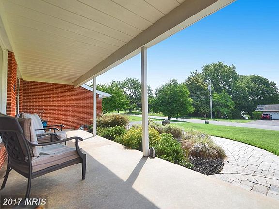 Spacious front porch and lovely paver patio walkwa