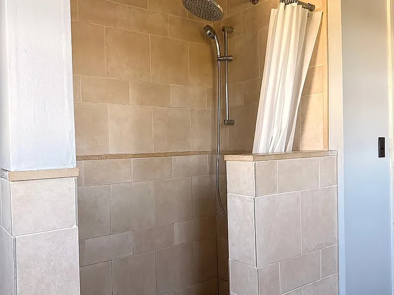 Large rain shower with complimentary mounted shower nozzle that can become a handheld shower for all bathing preferences.