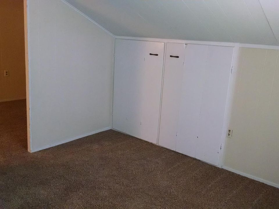 Upstairs bedroom, showing door and closet.
