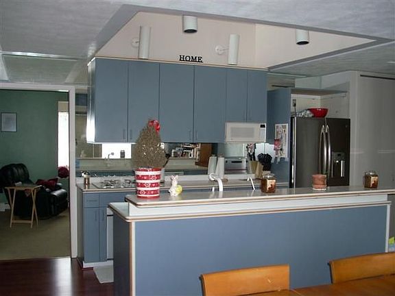 Open contemporary kitchen view from dining area (loft above)