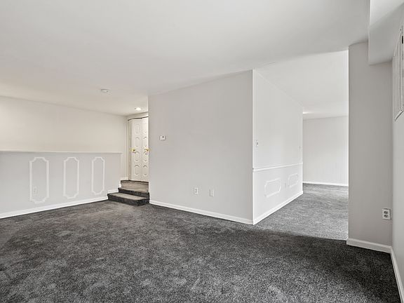 Living area looking toward entry and formal dining area to the right