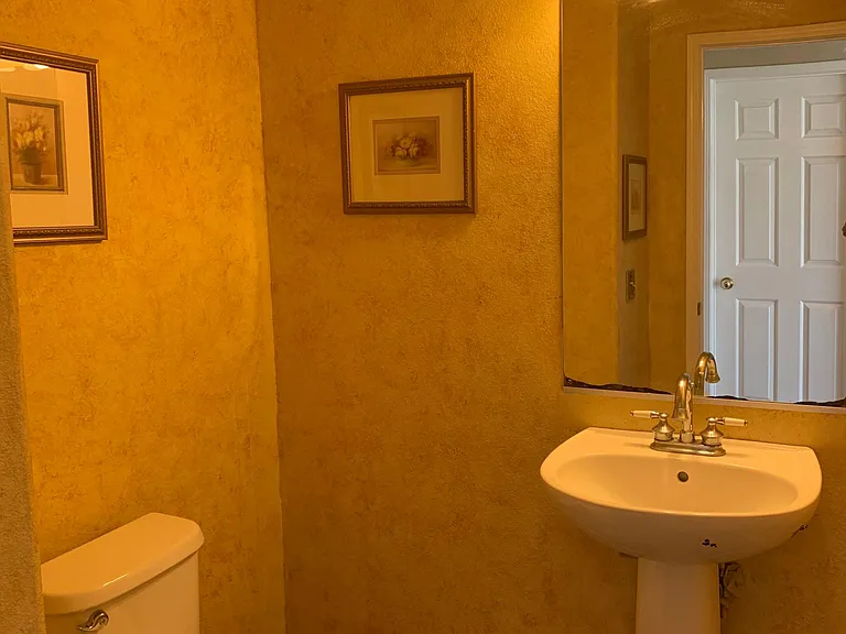 Convenient restroom on ground floor with hardwood floor.