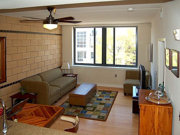 Spacious living room with brick wall