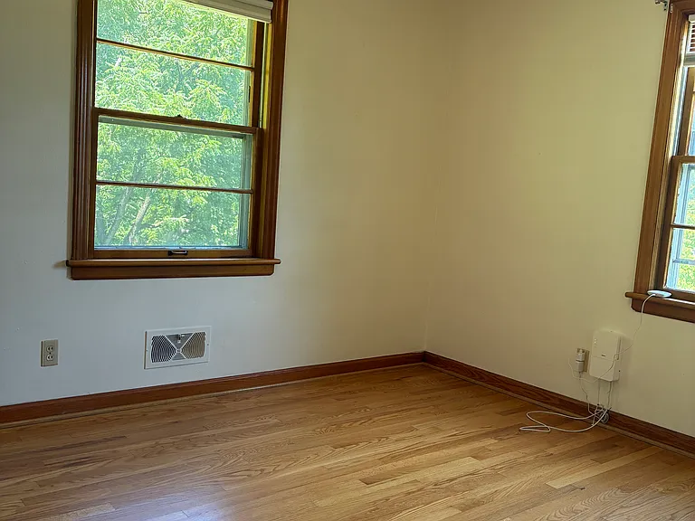 Third bedroom with hardwood floors, closet storage, and natural light.