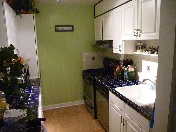 Half of kitchen. Breakfast bar and fridge in new portion.