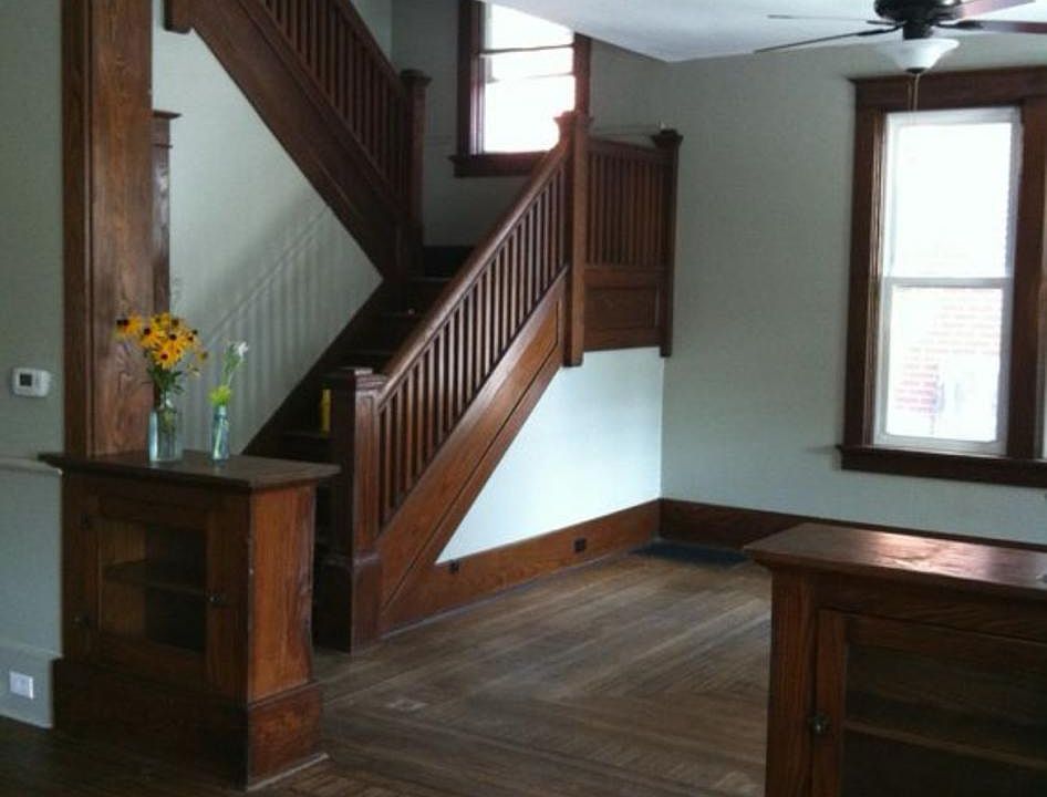 Stairway off front parlor inlaid hardwood flooring