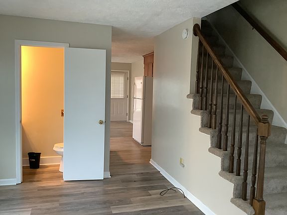 Stairway leading to upstairs bedrooms and full bathroom