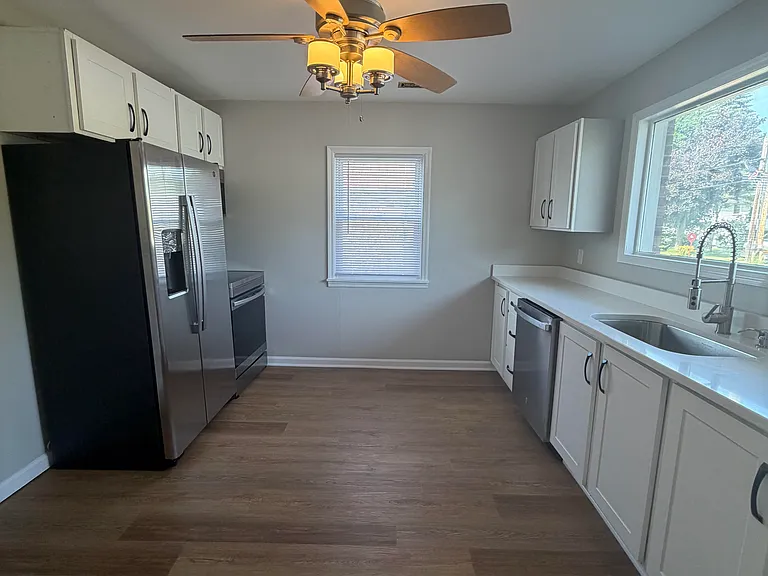 Large kitchen with brand new stainless steel appliances, quartz counter tops, pantry, Plenty of space for a table and chairs