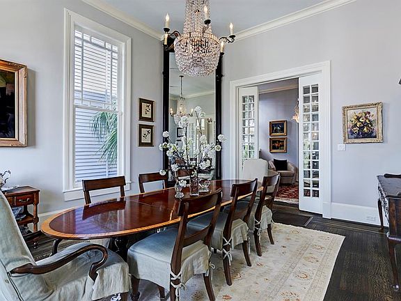 Intricate details are key to this home: soaringceilings, crown molding, large windows, chandelier,tiger-eye oak flooring, and extra storage.