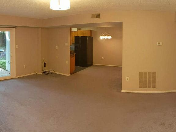 Big living room with walk out to patio. Open access to dining room and kitchen.