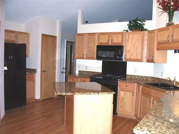 Equisite kitchen with grourmet cookwear, new hardwood floors and granite