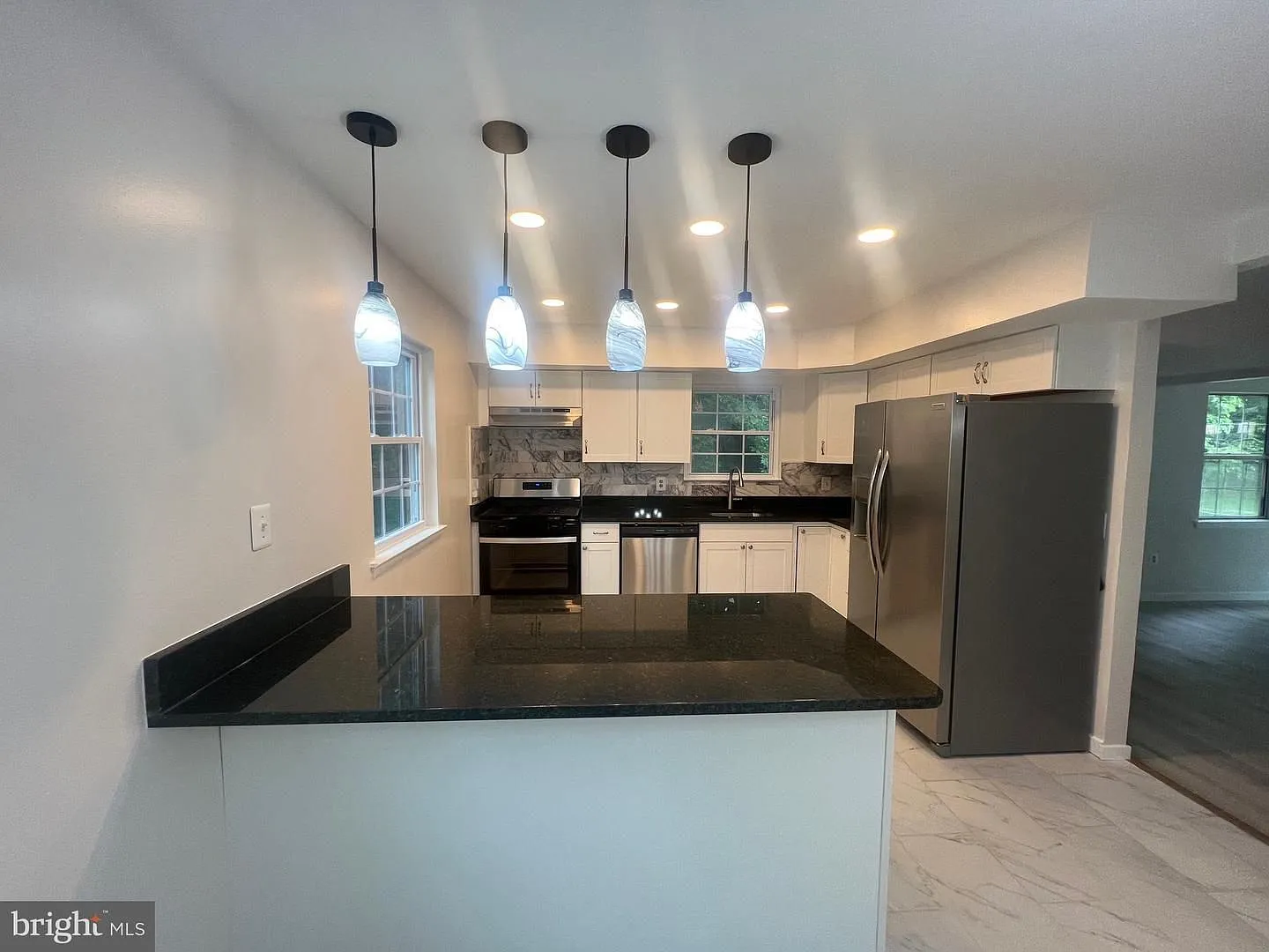 Welcome home to this beautifully updated end unit residence that combines modern finishes with sp... — Photo 4