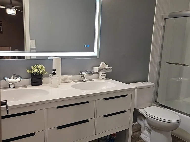 Master bathroom with double faucets.