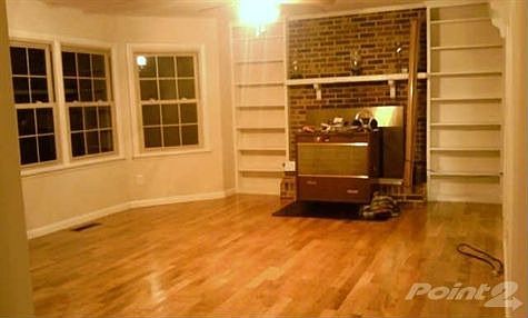 HUGE LIVING ROOM WITH LOTS OF WINDOWS, FIREPLACE, WOOD FLOOR, STOVE IS ADD'L FORM OF HEAT THAT CAN B