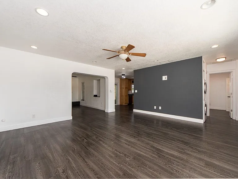 Living room with nice accent wall is wired up for a large TV
