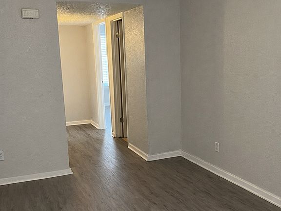 Spacious living room with modern flooring and fresh neutral tones.