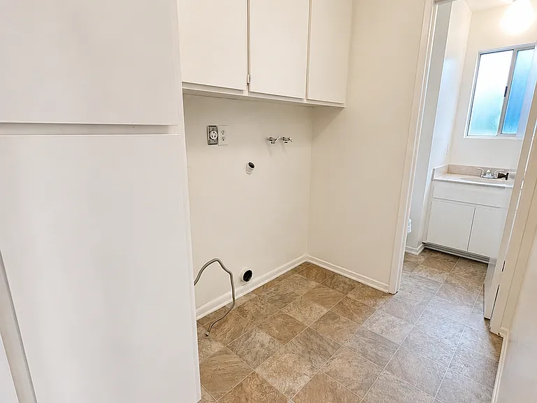 Laundry hookups with extra cabinets.