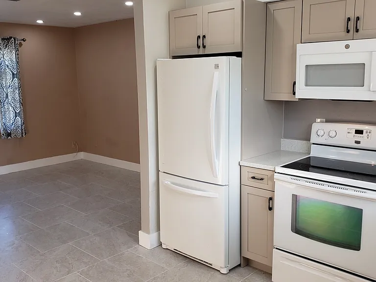 Viewing Small Part of Kitchen Looking toward part of Living Room area.