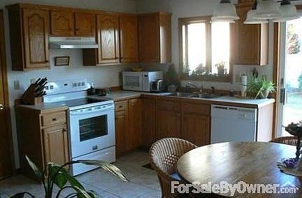 Kitchen : Sunny and pleasant, featuring a new stove and tile floors.