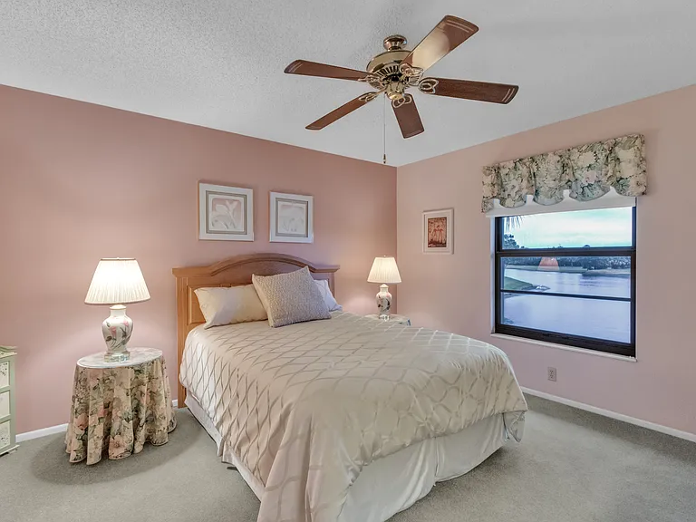 Spacious Primary Bedroom w/ gorgeous lake & golf course views!