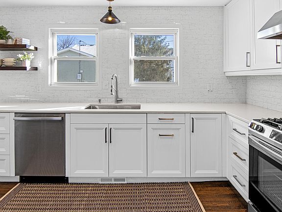 Kitchen sink, dishwasher, and open shelving