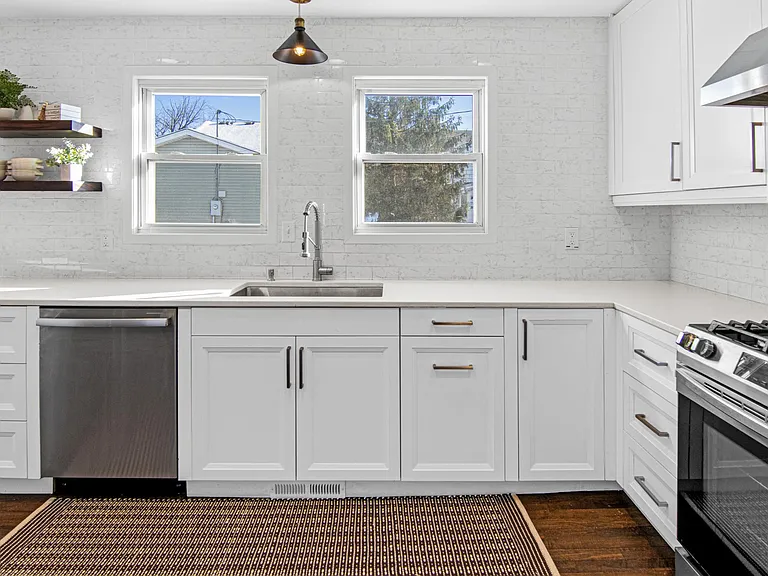Kitchen sink, dishwasher, and open shelving